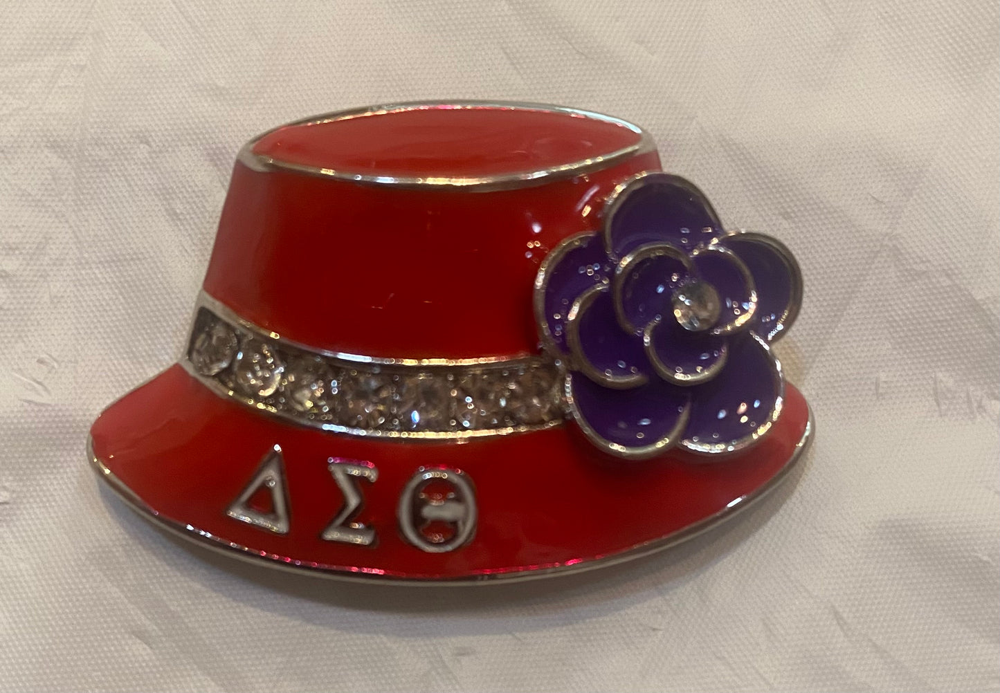 DST-DST RED HAT LAPEL PIN WITH WHITE DST LETTERS/CLEAR STONES AND VIOLET BROOCH-M