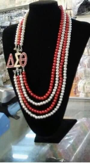 DST-RED AND WHITE PEARL NECKLACE WITH DST LETTERS